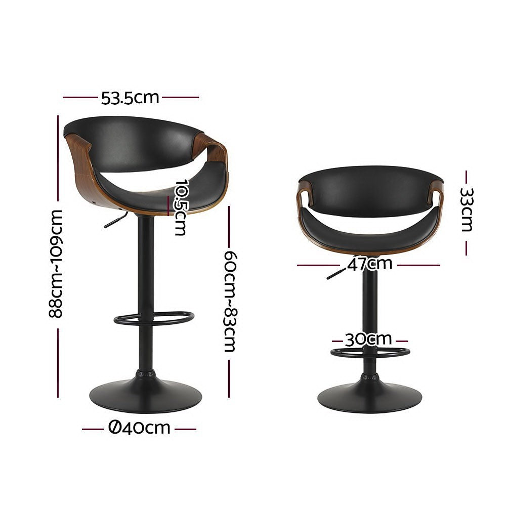 Tenby Point black gas lift swivel bar stool with curved backrest in a modern kitchen