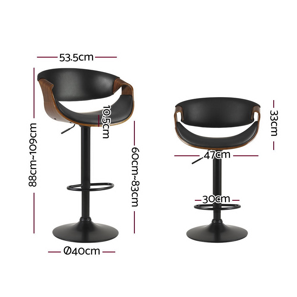 Tenby Point black gas lift swivel bar stool with curved backrest in a modern kitchen