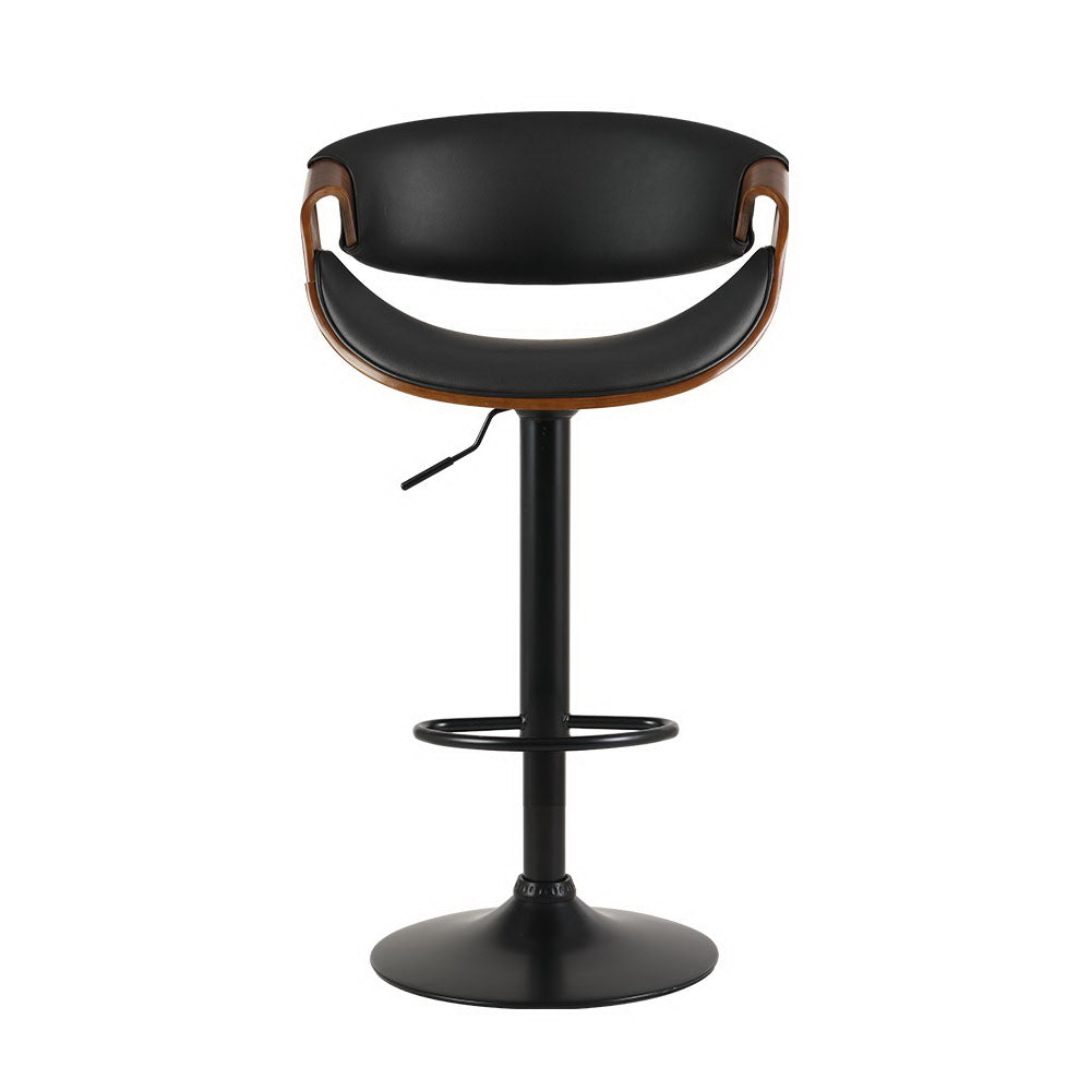 Tenby Point black gas lift swivel bar stool with curved backrest in a modern kitchen
