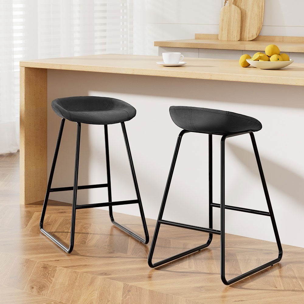 Sullivan Bay black faux leather padded metal bar stool at a kitchen counter