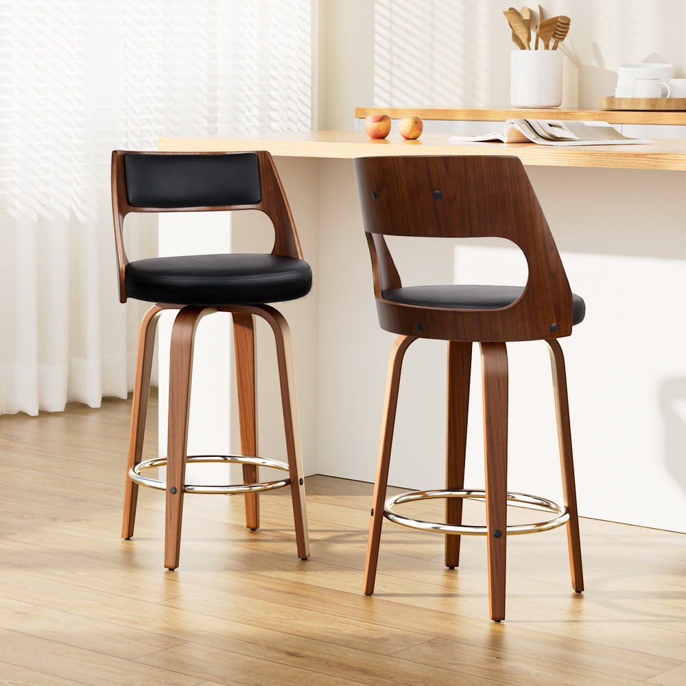 Highett black swivel faux leather bar stool with walnut legs in a modern kitchen