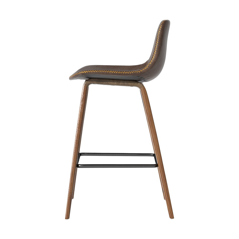 Devilbend walnut wooden bar stool with faux leather seat in a warm kitchen