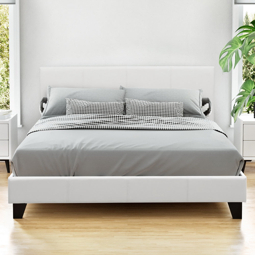 Como white Queen bed frame in a modern bedroom