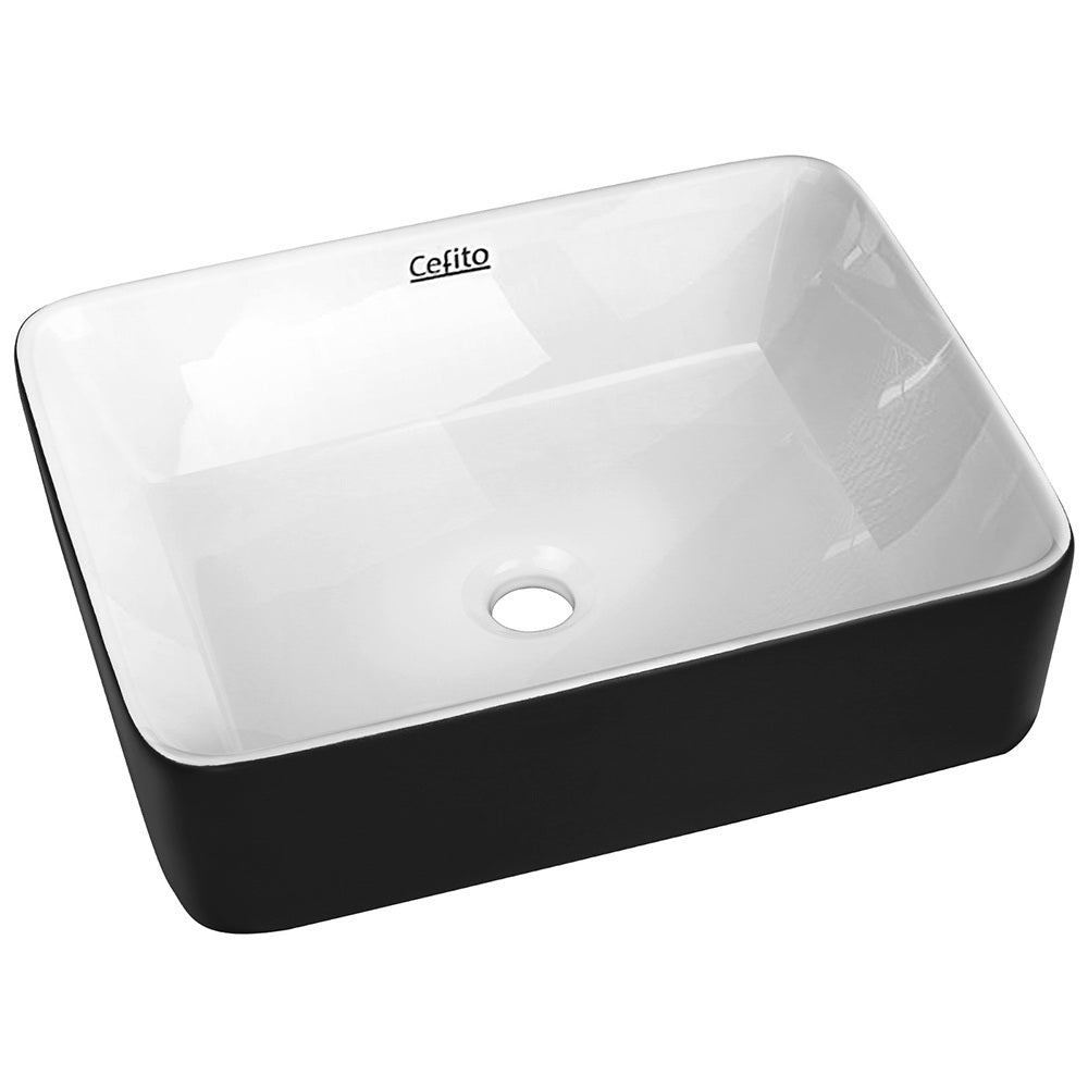 Oval ceramic vessel basin with matte black exterior and white interior, 48x37cm