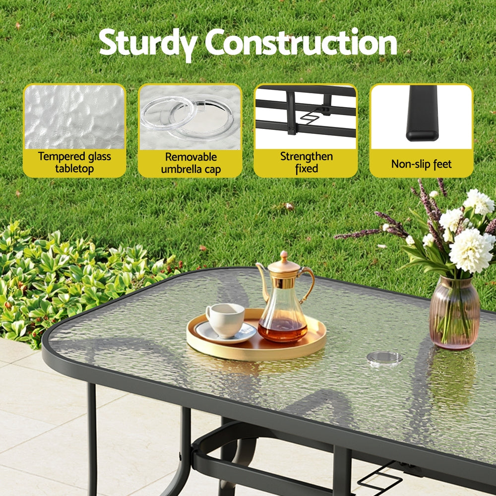 Five piece outdoor dining set with 120cm glass table and four black Textilene chairs
