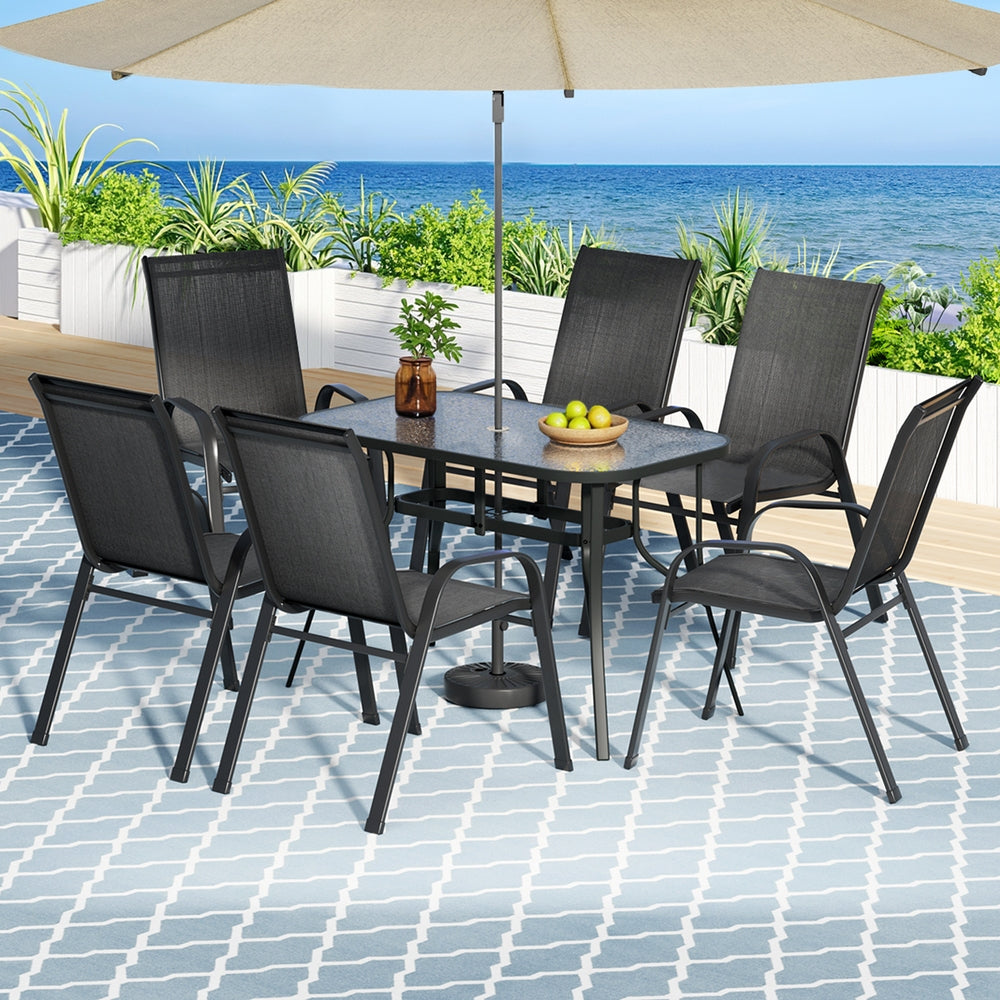 Seven piece outdoor dining set with glass table and six black Textilene chairs