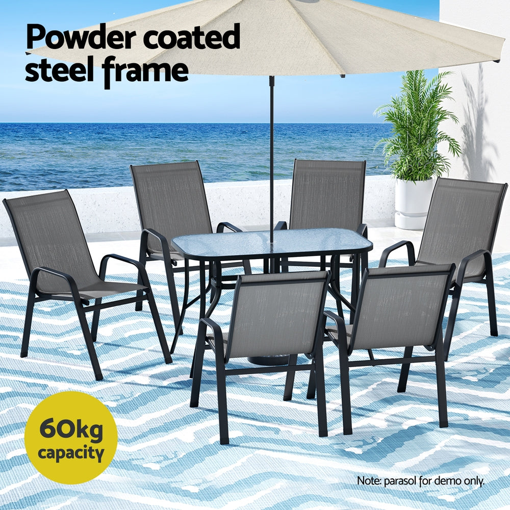 Seven piece grey outdoor dining set arranged on a patio