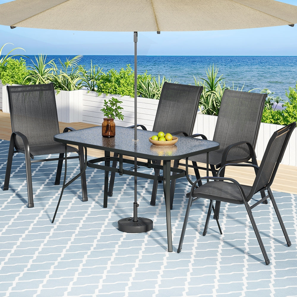 Five piece outdoor dining set with glass table and four black Textilene chairs
