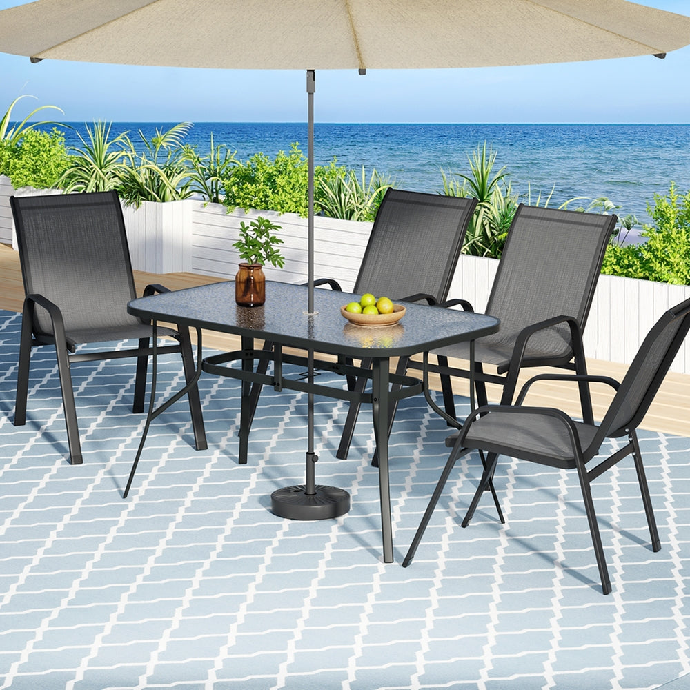 Five piece outdoor dining set with glass table and four grey Textilene chairs