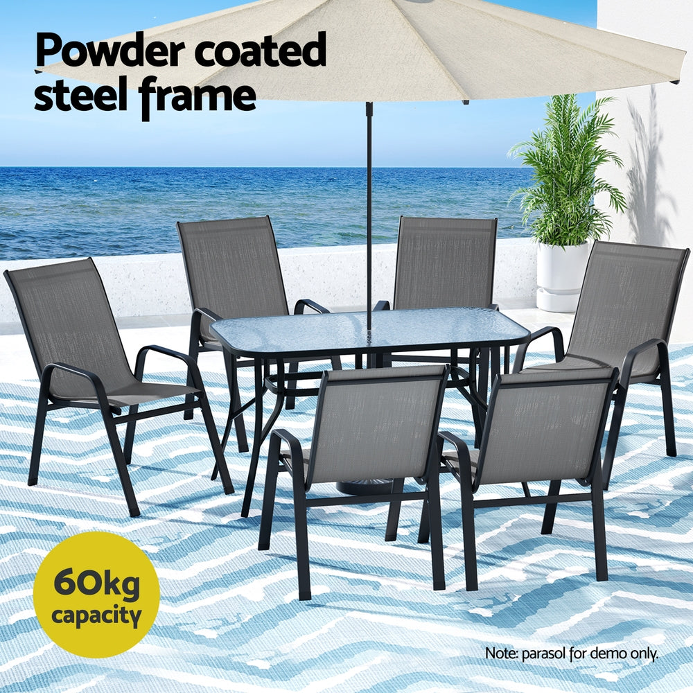 Seven piece outdoor dining set with glass table and six grey Textilene chairs