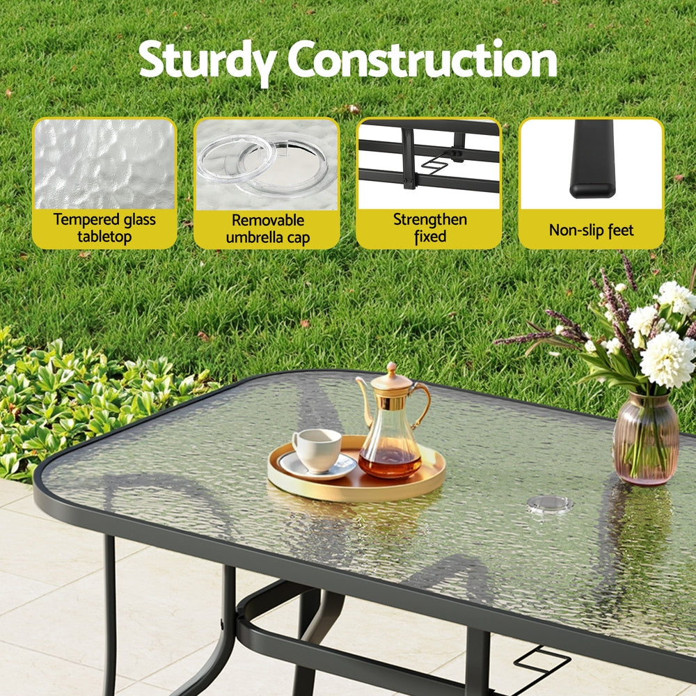 Seven piece outdoor dining set with glass table and six grey Textilene chairs