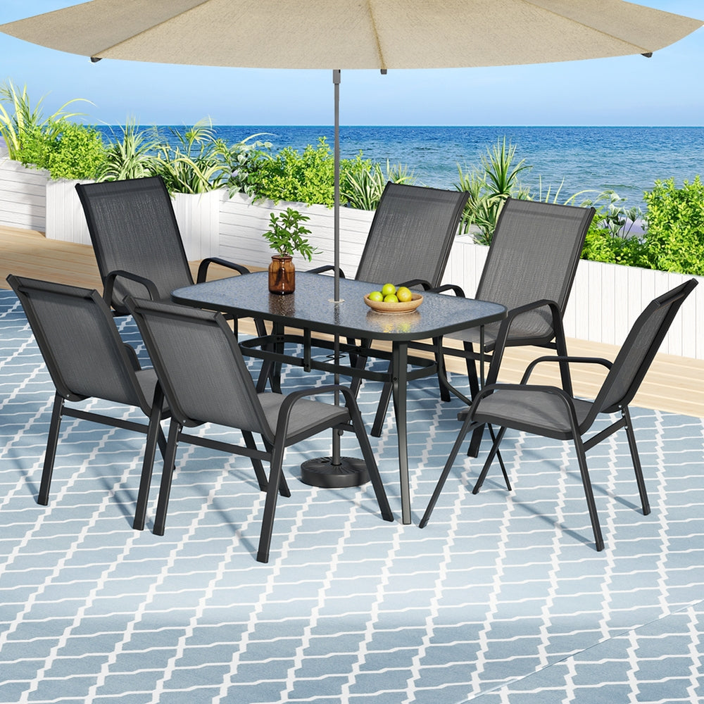 Seven piece outdoor dining set with glass table and six grey Textilene chairs