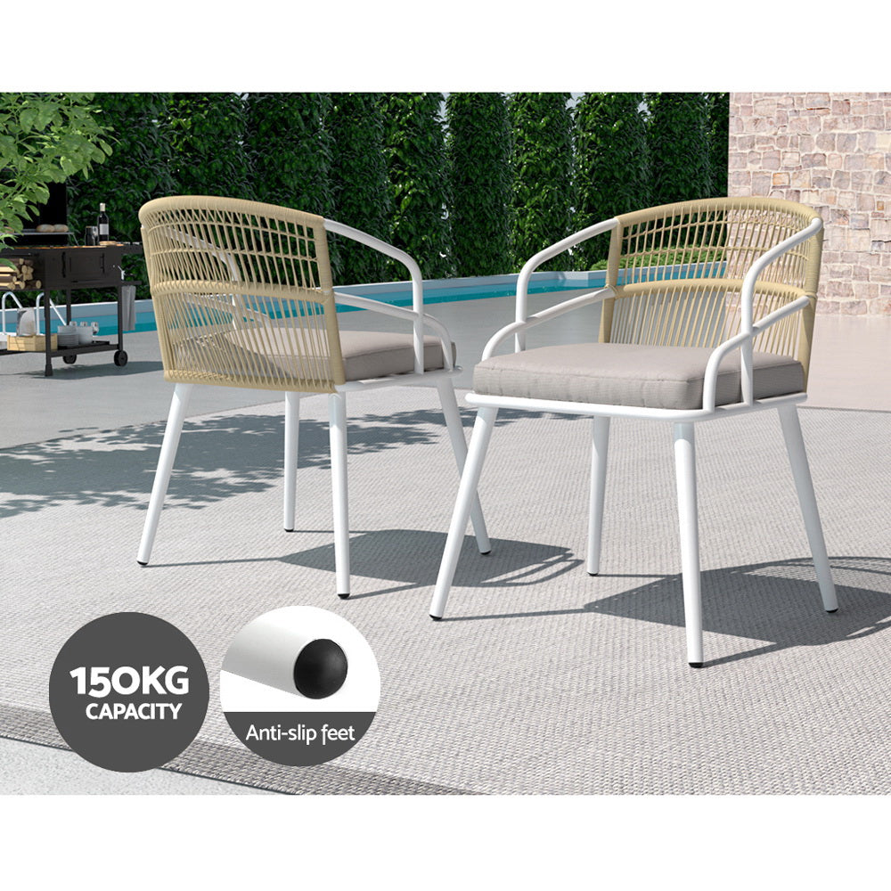 White outdoor dining set arranged on a patio