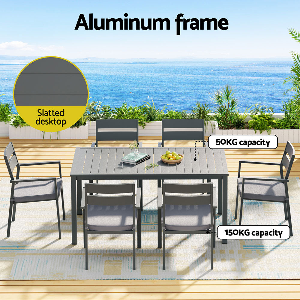 Seven piece aluminium dining set arranged in a backyard