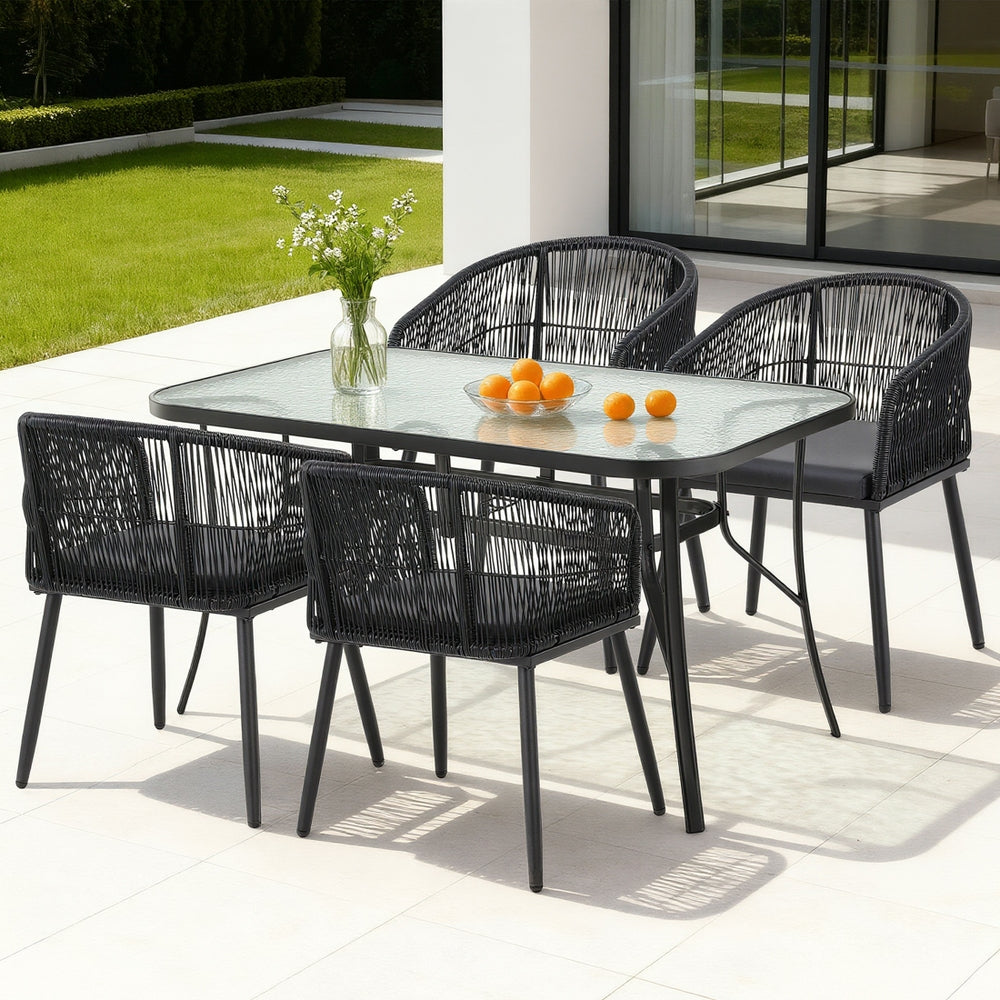 5 piece black rattan outdoor dining set with glass table and four wicker chairs