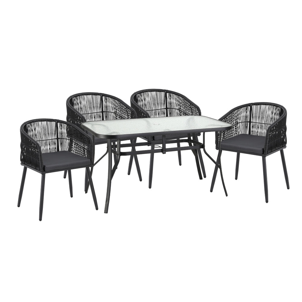 Rattan outdoor dining set arranged on a patio