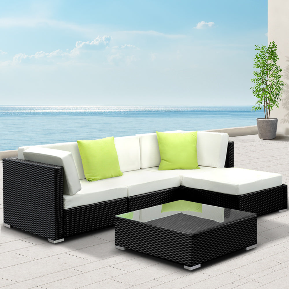 Hervey Bay black wicker outdoor corner lounge set in an outdoor setting
