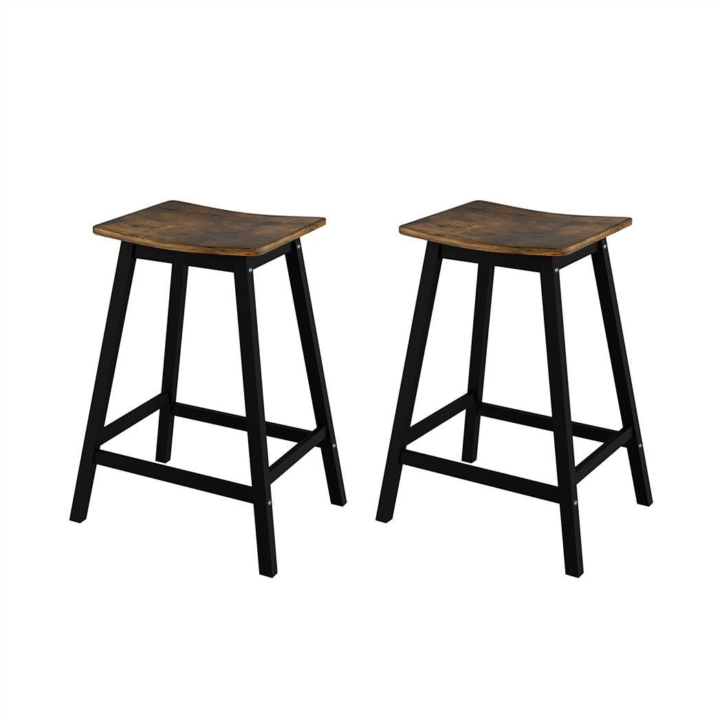Edithvale rustic brown wooden bar stool with saddle seat in an industrial kitchen