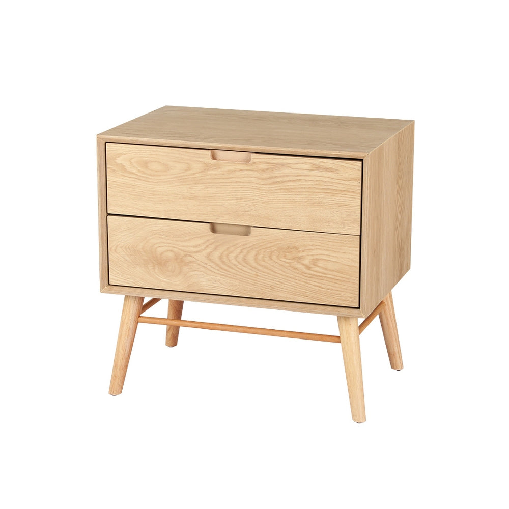 Federal pine two drawer bedside table with splayed ash wood legs in a rustic bedroom