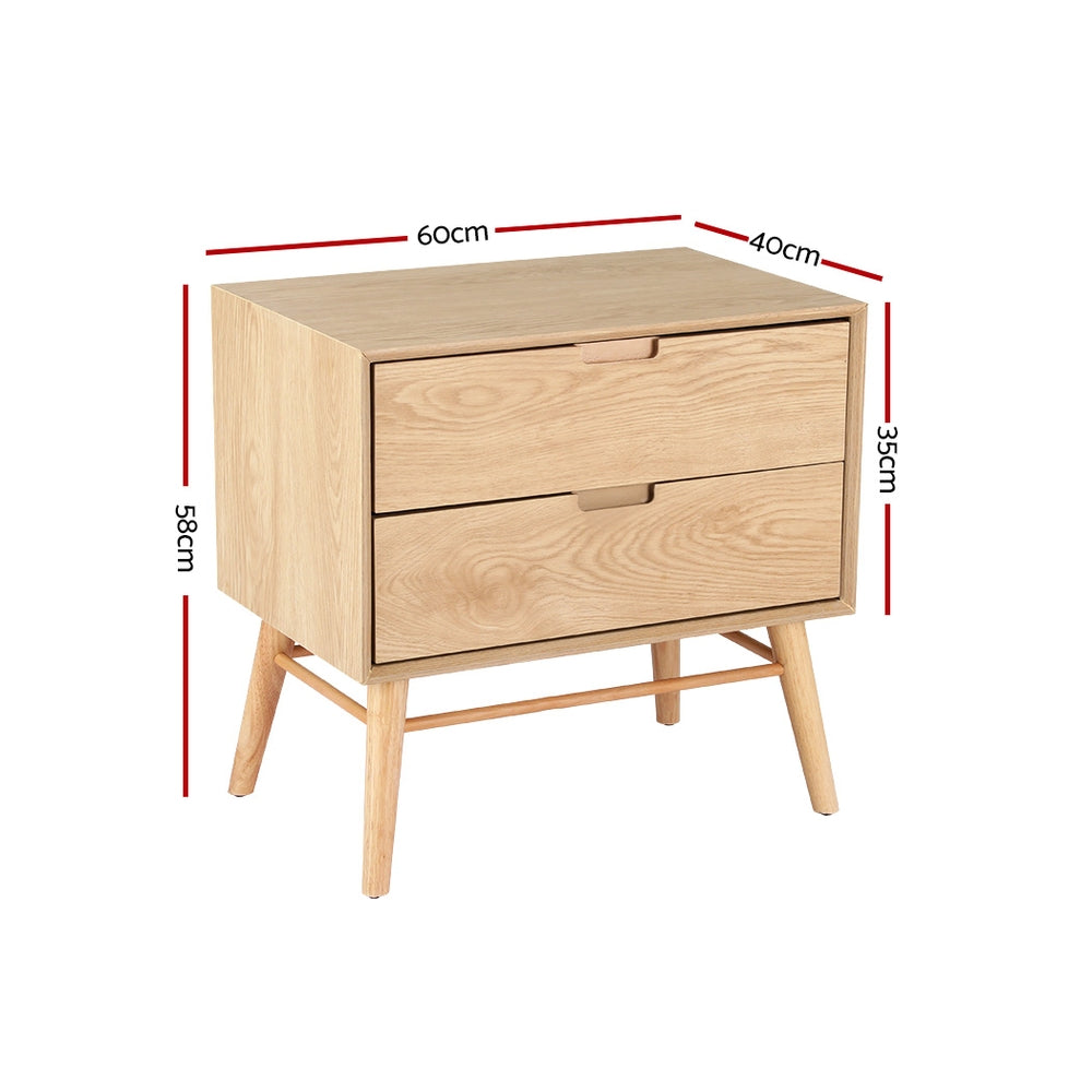 Federal pine two drawer bedside table with splayed ash wood legs in a rustic bedroom