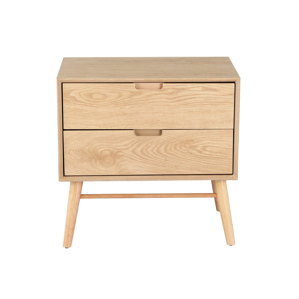Federal pine two drawer bedside table with splayed ash wood legs in a rustic bedroom