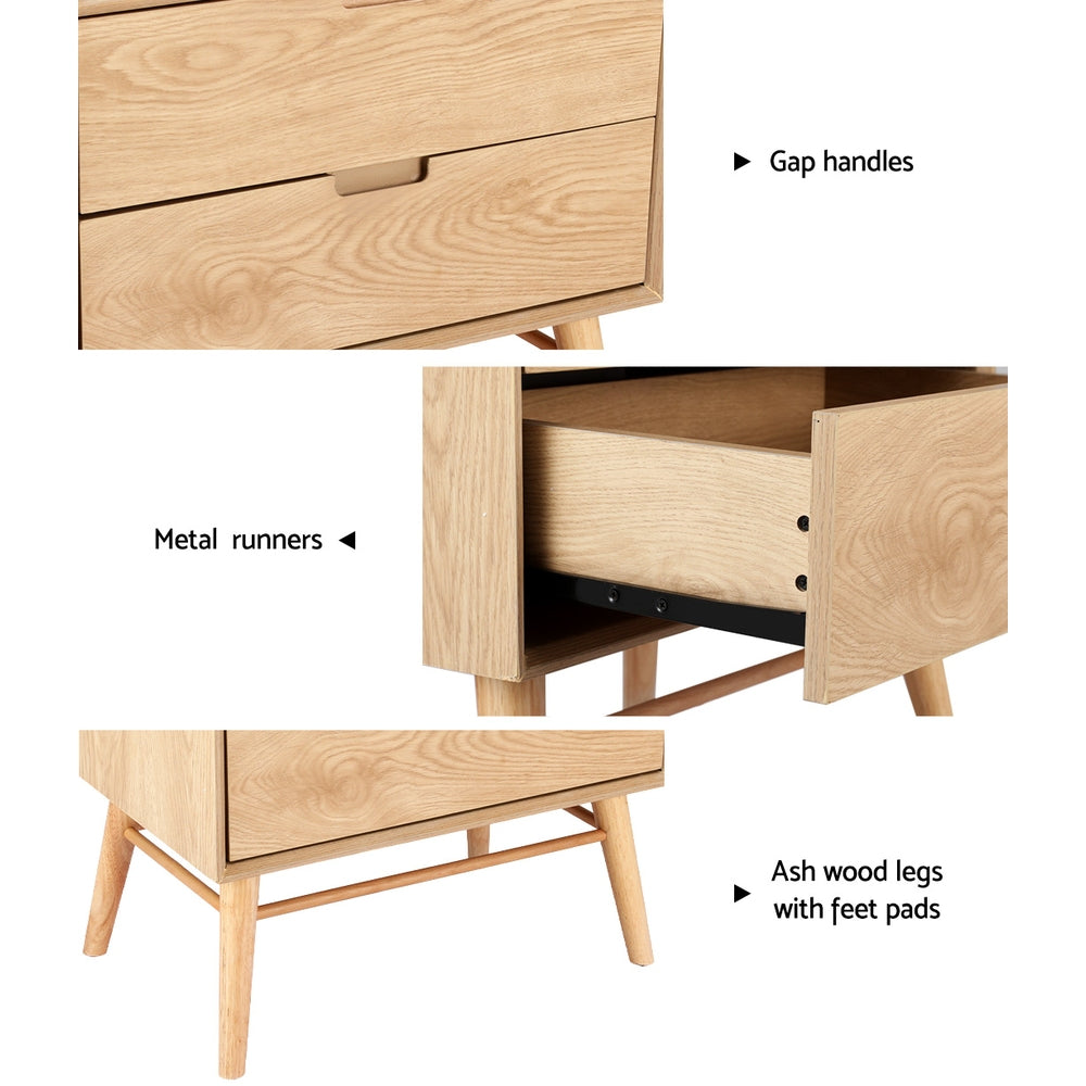 Federal pine two drawer bedside table with splayed ash wood legs in a rustic bedroom
