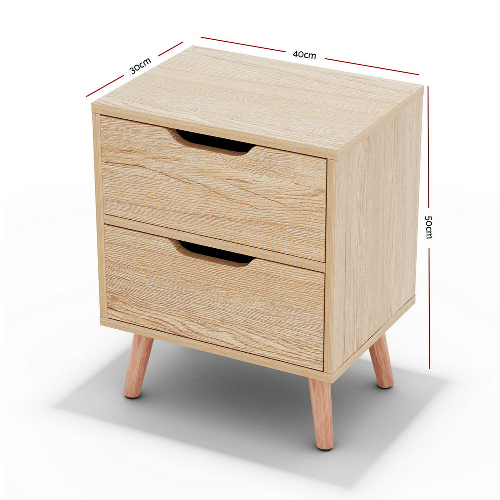 The Channon pine two drawer bedside table with splayed beech legs in a modern bedroom