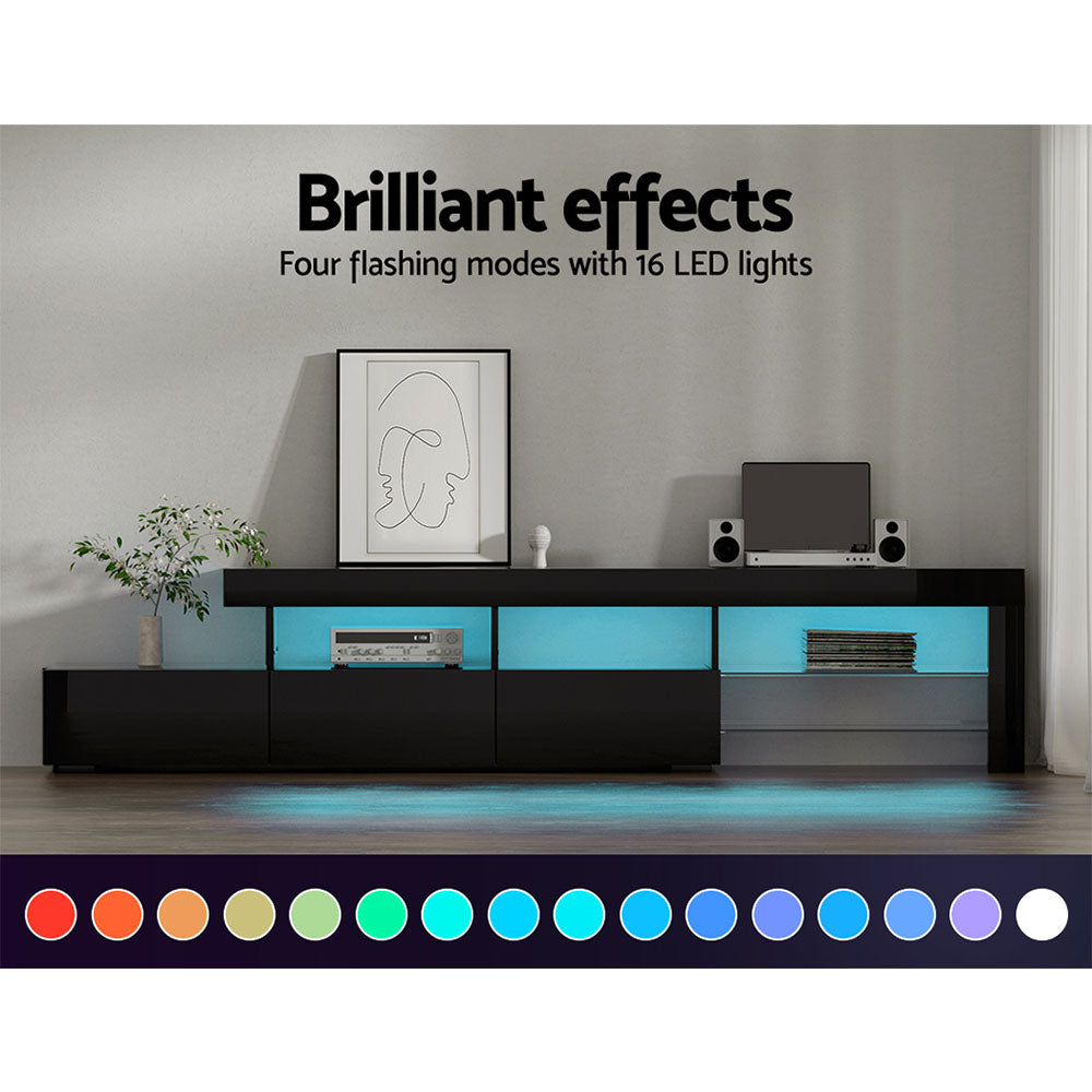 Penguin 215cm black LED entertainment unit with colour changing lighting and glass shelves in a modern living room