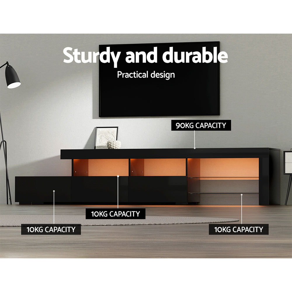 Penguin 215cm black LED entertainment unit with colour changing lighting and glass shelves in a modern living room