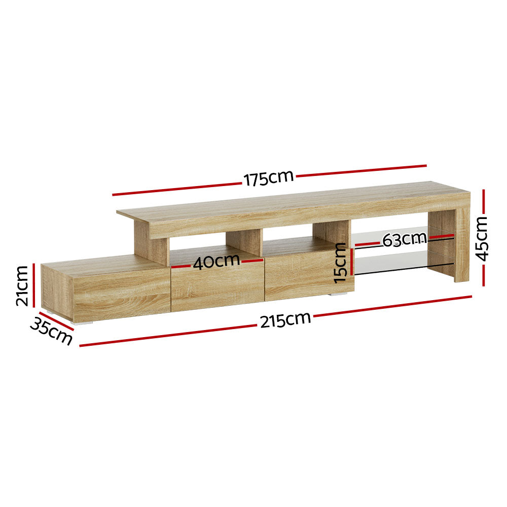 Penguin 215cm pine LED entertainment unit with colour changing lighting and glass shelves in a modern living room