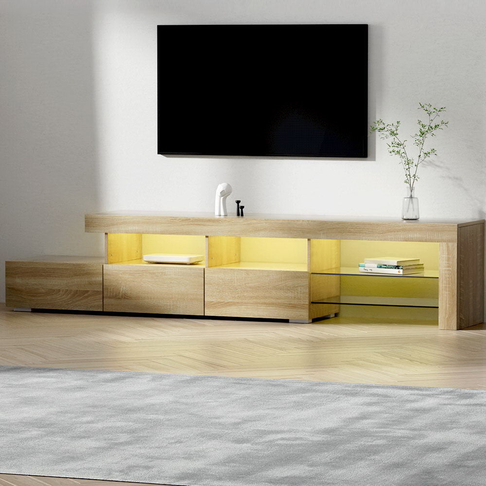 Penguin 215cm pine LED entertainment unit with colour changing lighting and glass shelves in a modern living room