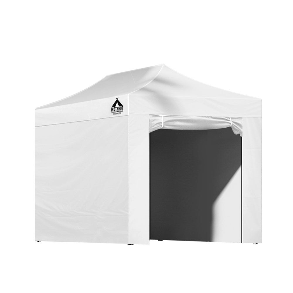 White gazebo folded down next to its carry bag ready to transport