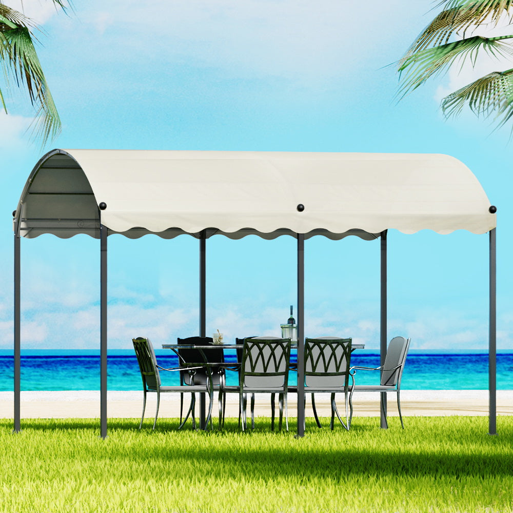 Beige 4 x 3 m iron art gazebo with decorative steel frame in a garden