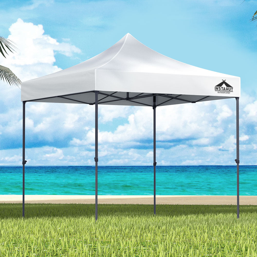 White 3 x 3 m pop up gazebo set up outdoors with open sides