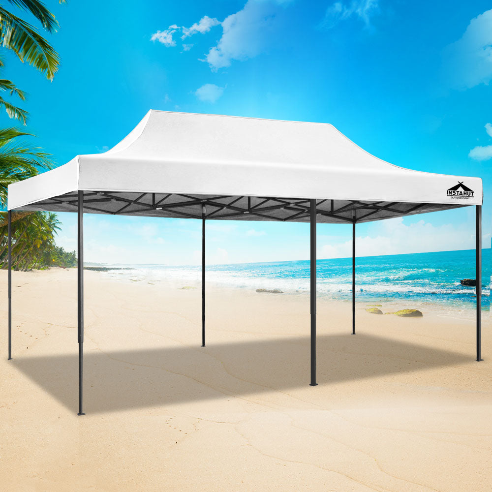 White pop up gazebo folded down to its compact size for storage