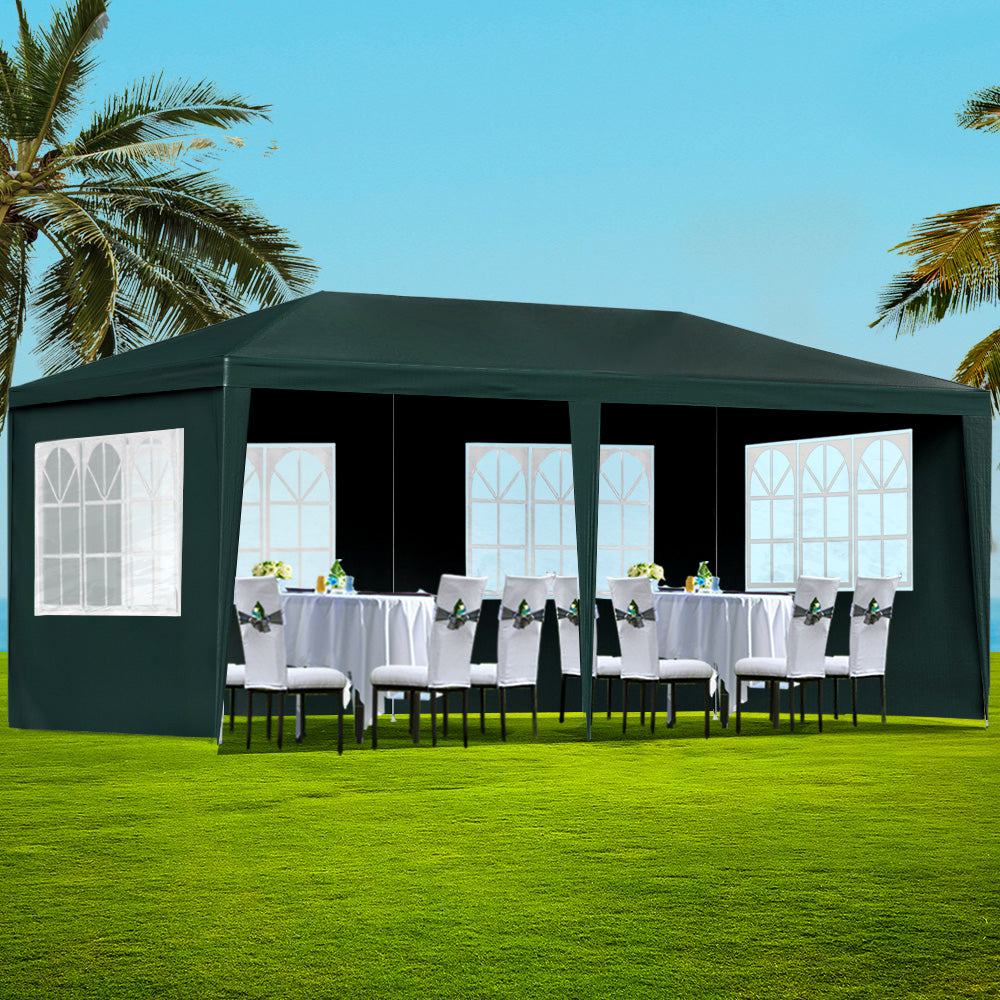 Green 3 x 6 m marquee gazebo set up outdoors with window side panels fitted