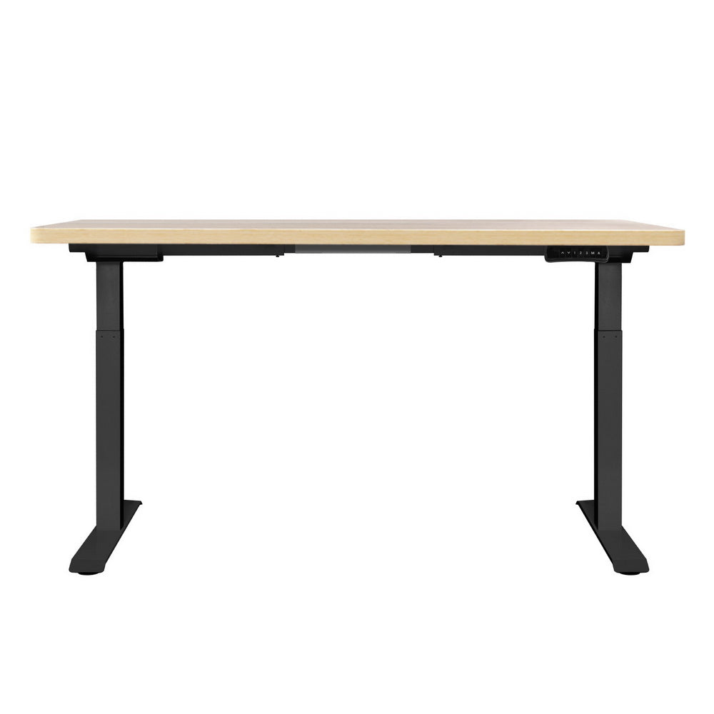 Manuka oak electric standing desk with black frame in a home office