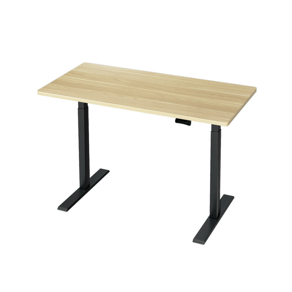 Manuka oak electric standing desk with black frame in a home office