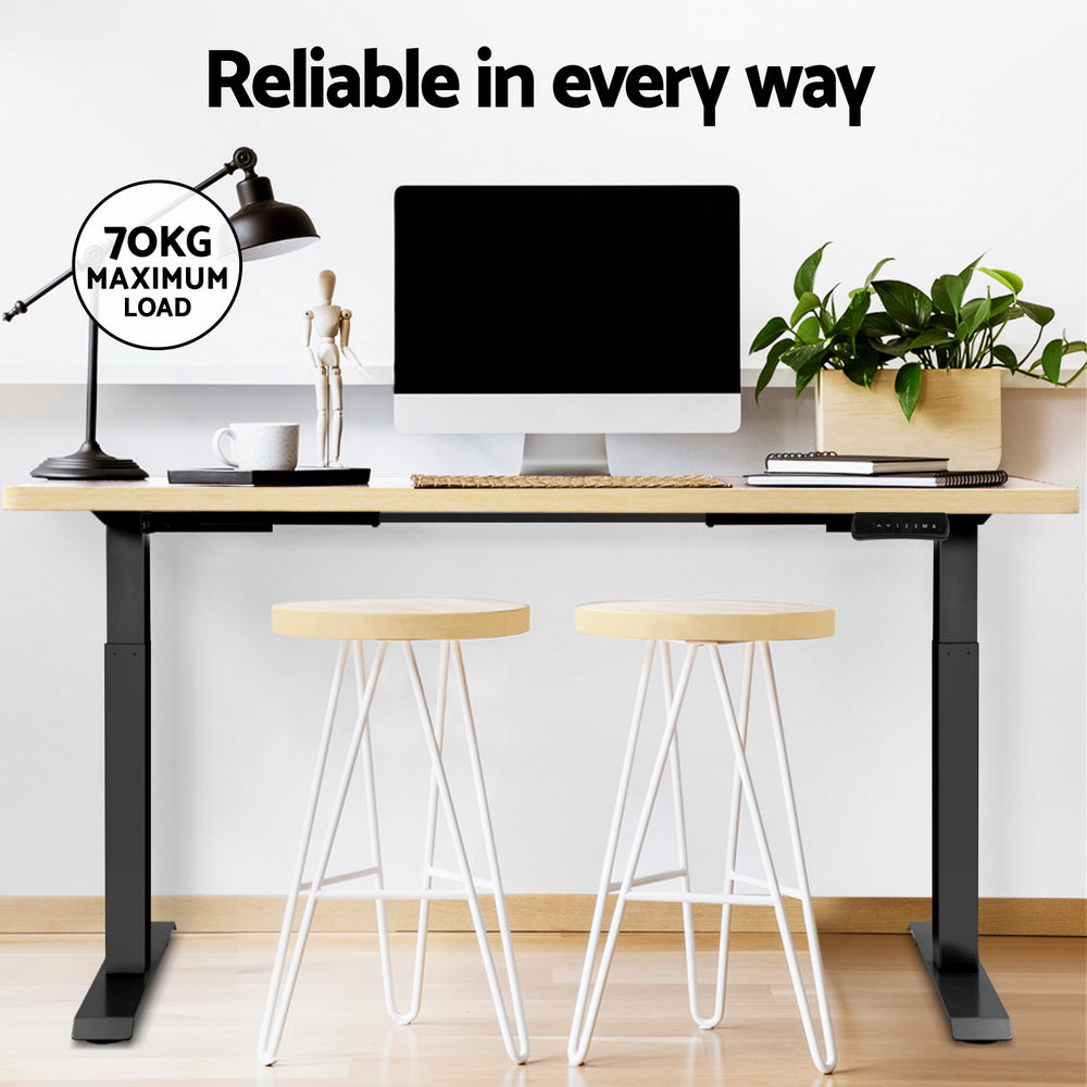 Manuka oak electric standing desk with black frame in a home office