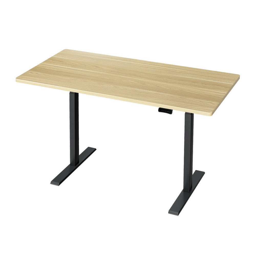 Manuka oak electric standing desk with black frame in a home office