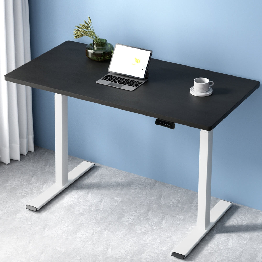 Manuka black electric standing desk with white frame in a home office