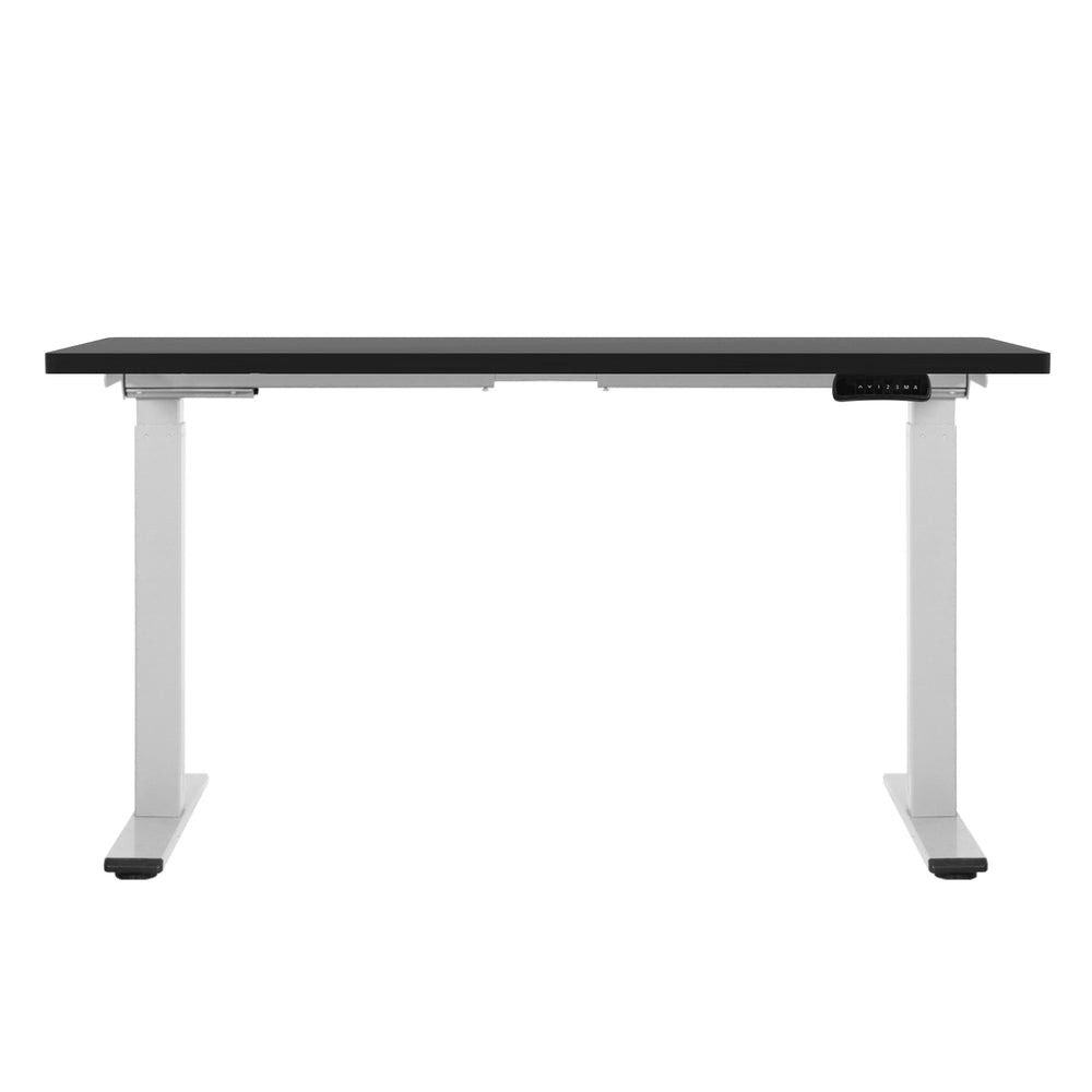 Manuka black electric standing desk with white frame in a home office