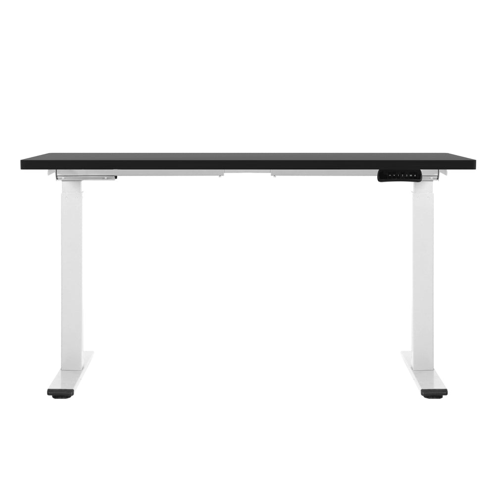 Manuka black electric standing desk with white frame in a home office
