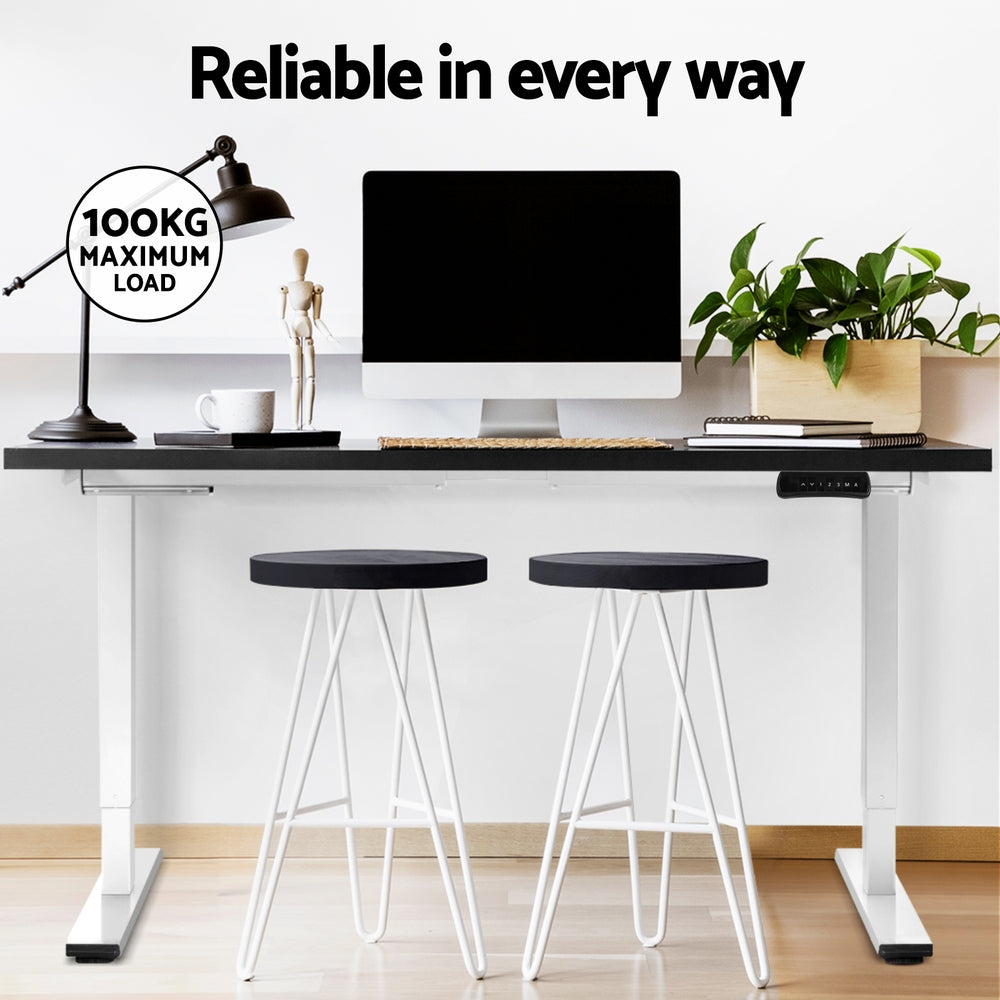 Manuka black electric standing desk with white frame in a home office
