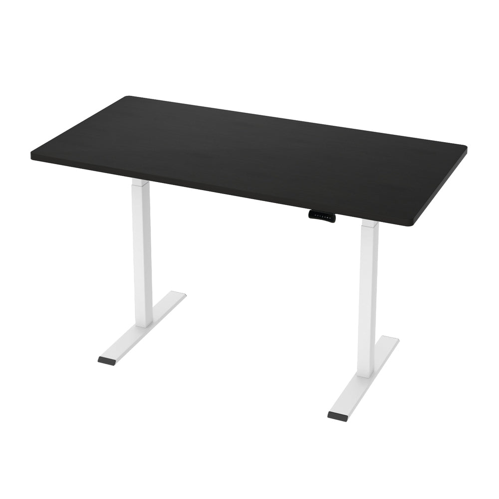 Manuka black electric standing desk with white frame in a home office