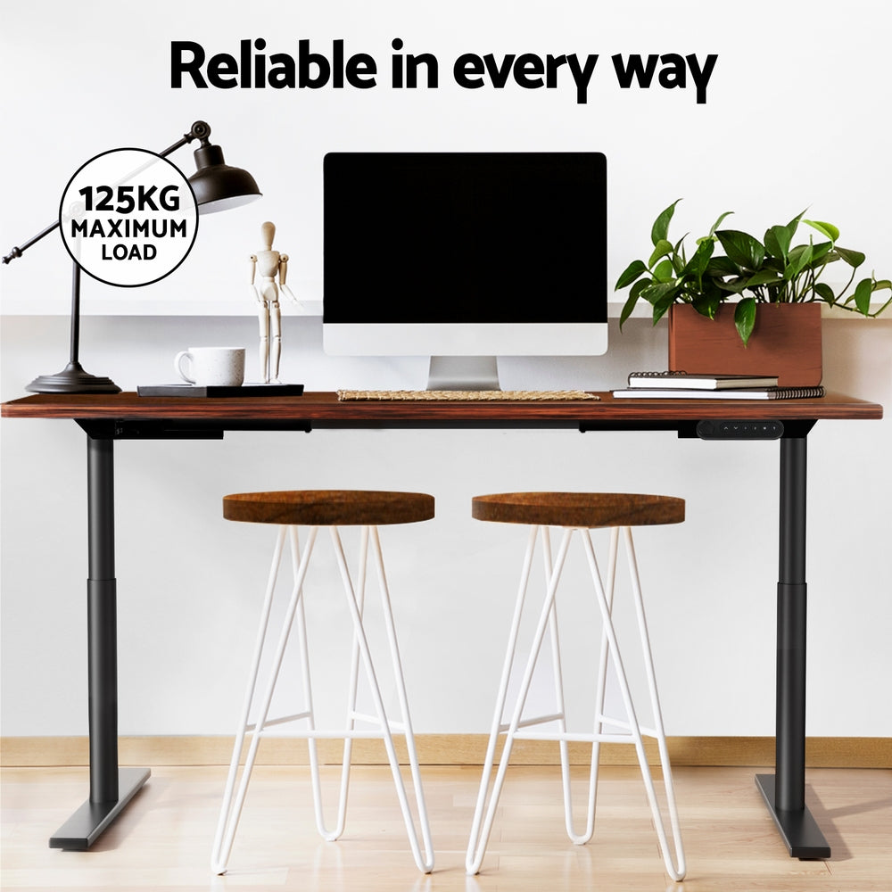 Braddon rustic brown electric standing desk with black frame in a home office