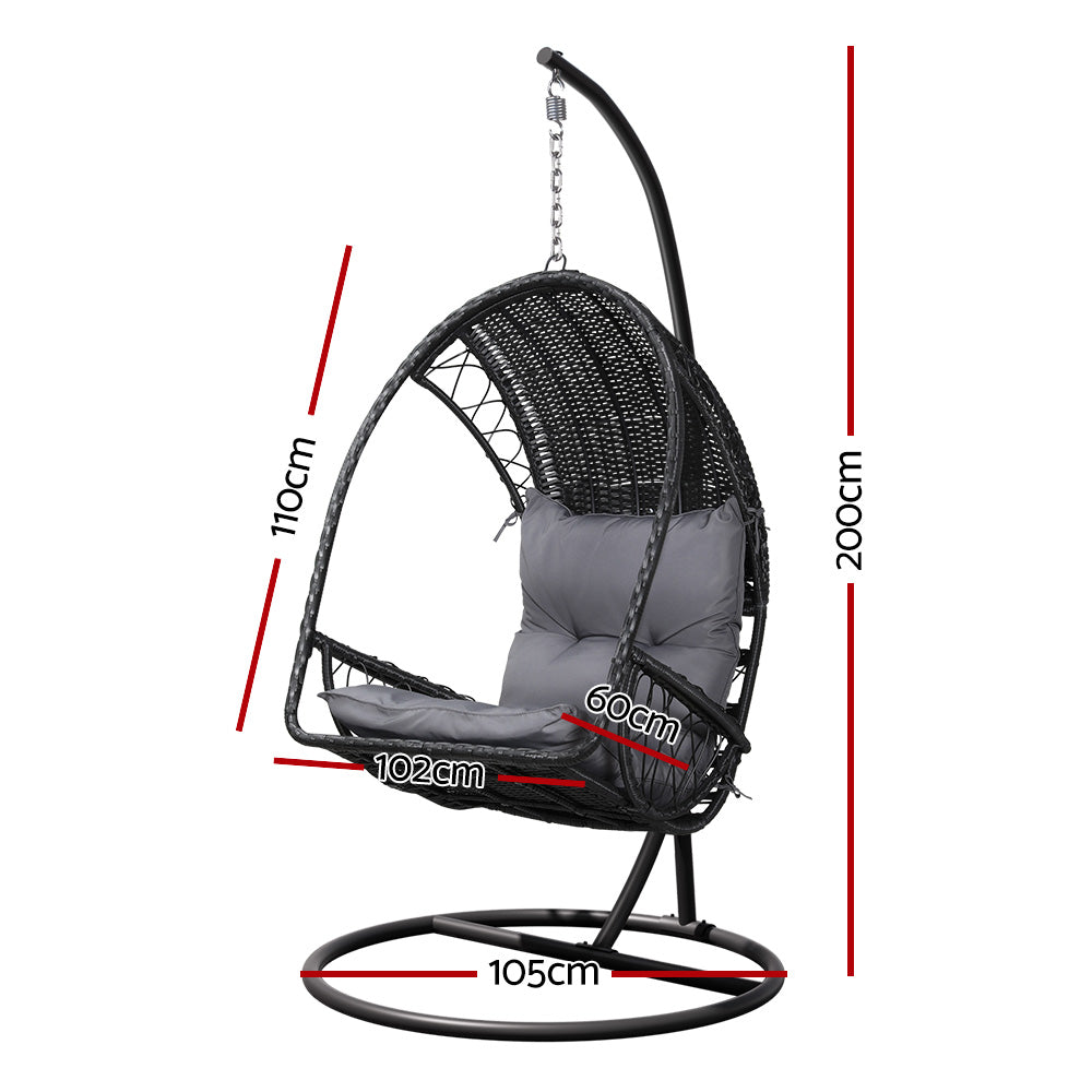 Gerroa black resin wicker hanging egg chair with stand on a patio