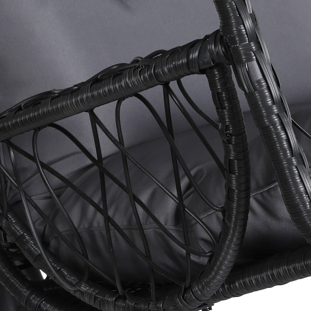 Gerroa black resin wicker hanging egg chair with stand on a patio