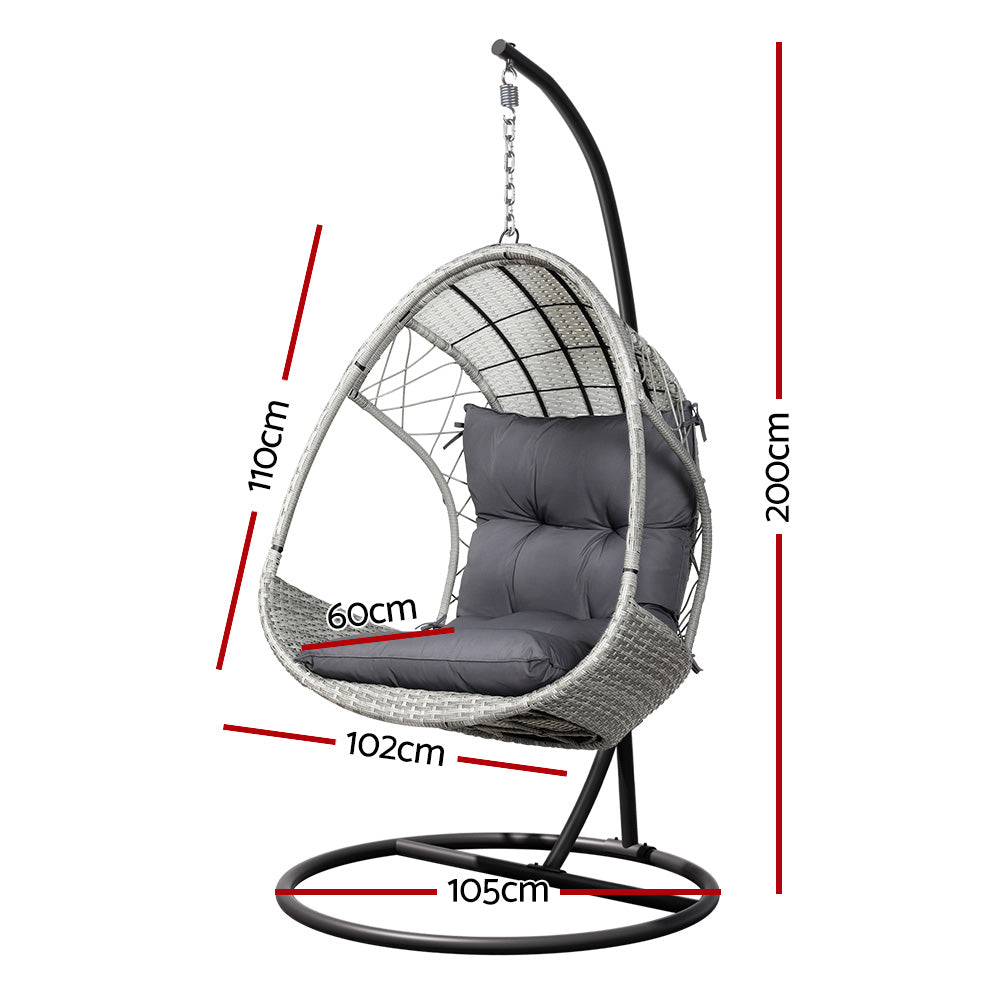 Gerroa light grey resin wicker hanging egg chair with stand on a patio