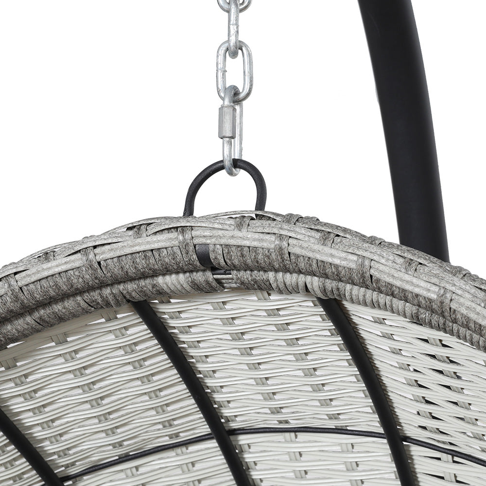 Gerroa light grey resin wicker hanging egg chair with stand on a patio